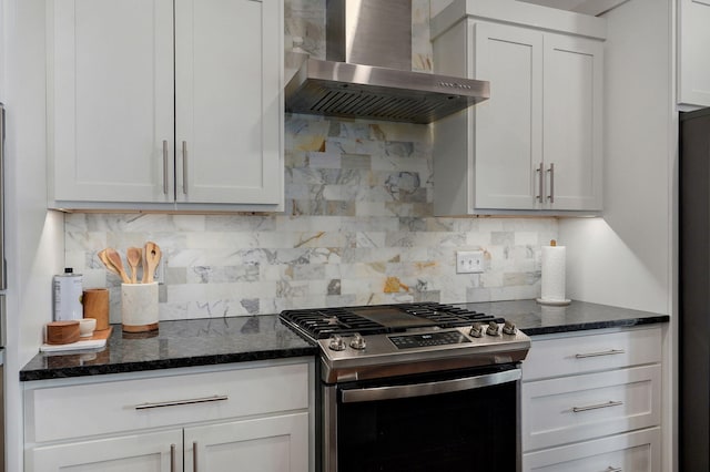735 N Fox Hill Cir, Nixa, MO 65714 - kitchen with stainless steel gas range, wall chimney exhaust hood, decorative backsplash, dark stone counters, and white cabinets