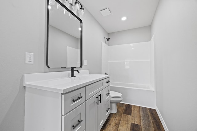 1079 Wiseman Rd, Marshfield, MO 65706 - bathroom with vanity, toilet, wood finished floors, shower / tub combination, and recessed lighting