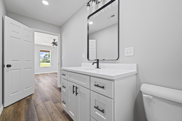 1079 Wiseman Rd, Marshfield, MO 65706 - bathroom featuring toilet, wood finished floors, vanity, recessed lighting, and baseboards