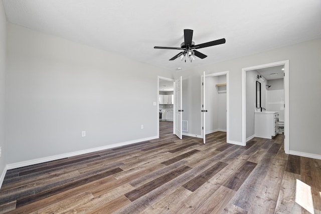 1079 Wiseman Rd, Marshfield, MO 65706 - unfurnished bedroom featuring wood finished floors, baseboards, a closet, and connected bathroom