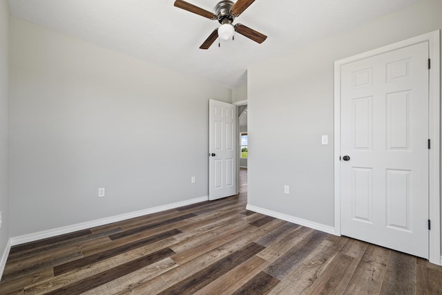 1079 Wiseman Rd, Marshfield, MO 65706 - unfurnished bedroom with dark wood finished floors, baseboards, and ceiling fan