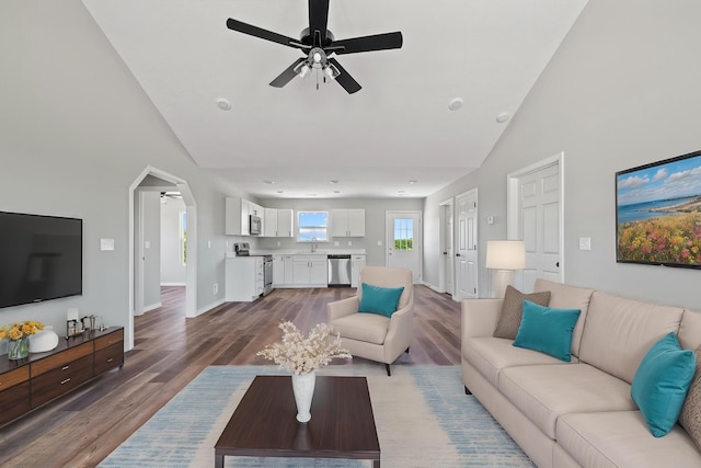 1079 Wiseman Rd, Marshfield, MO 65706 - living area with ceiling fan, wood finished floors, arched walkways, baseboards, and high vaulted ceiling