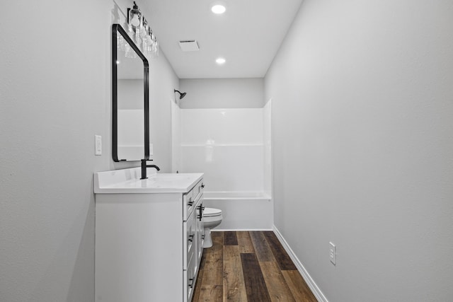 1079 Wiseman Rd, Marshfield, MO 65706 - bathroom with vanity, toilet, wood finished floors, shower / washtub combination, and recessed lighting