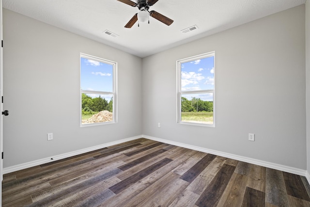 1079 Wiseman Rd, Marshfield, MO 65706 - spare room with plenty of natural light, baseboards, a ceiling fan, and dark wood-style flooring