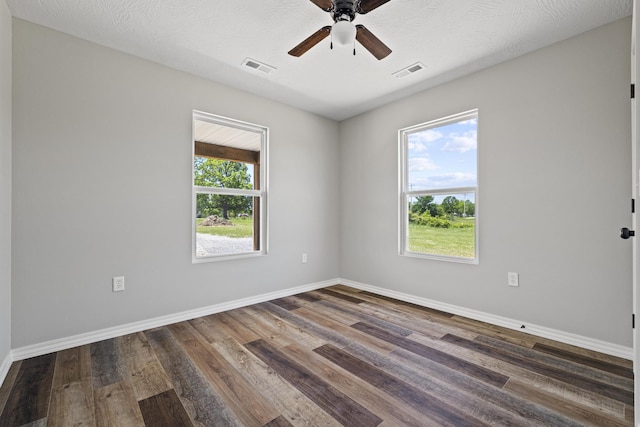 1079 Wiseman Rd, Marshfield, MO 65706 - spare room featuring wood finished floors, a ceiling fan, and baseboards