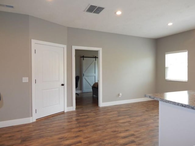 510 Kenny St, Ava, MO 65608 - unfurnished room featuring a barn door, dark wood finished floors, baseboards, and recessed lighting
