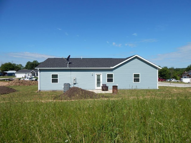 510 Kenny St, Ava, MO 65608 - back of house with central AC, a shingled roof, and a yard