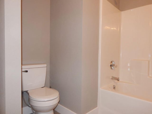 510 Kenny St, Ava, MO 65608 - full bathroom with baseboards, toilet, and shower / washtub combination