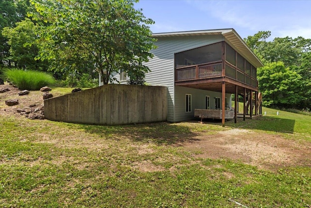 657 Plentywood Ln, Gainesville, MO 65655 - rear view of property featuring a sunroom, a carport, a lawn, and dirt driveway