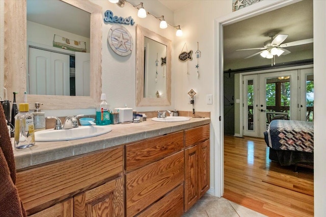 657 Plentywood Ln, Gainesville, MO 65655 - ensuite bathroom with double vanity, wood finished floors, and ceiling fan