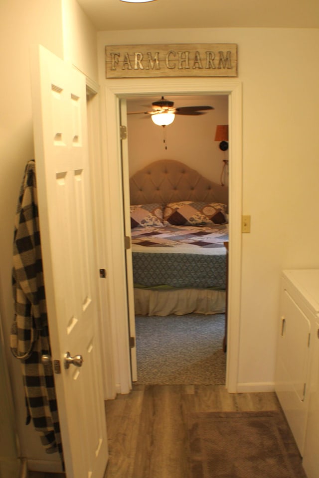 821 NW B Hwy, Osceola, MO 64776 - hallway featuring washer and dryer and dark wood-type flooring