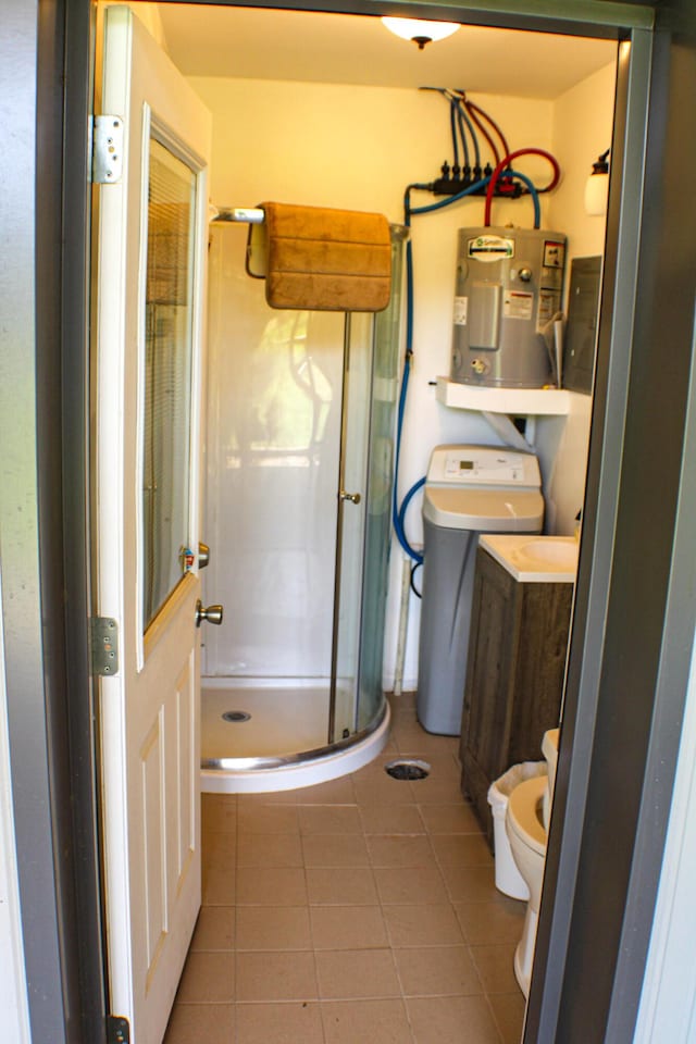 821 NW B Hwy, Osceola, MO 64776 - full bathroom featuring electric water heater, a stall shower, toilet, tile patterned flooring, and vanity