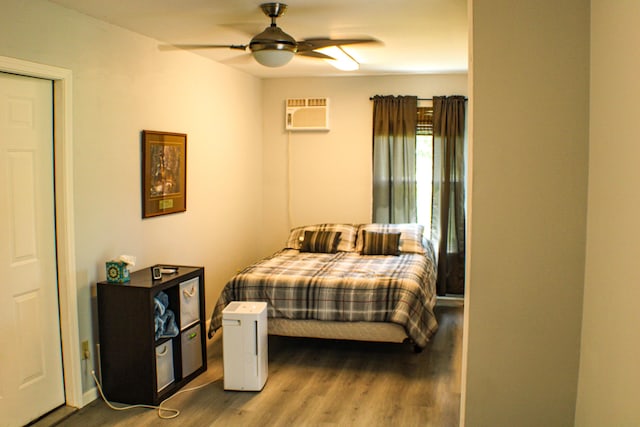 821 NW B Hwy, Osceola, MO 64776 - bedroom with wood finished floors, a wall mounted air conditioner, and a ceiling fan