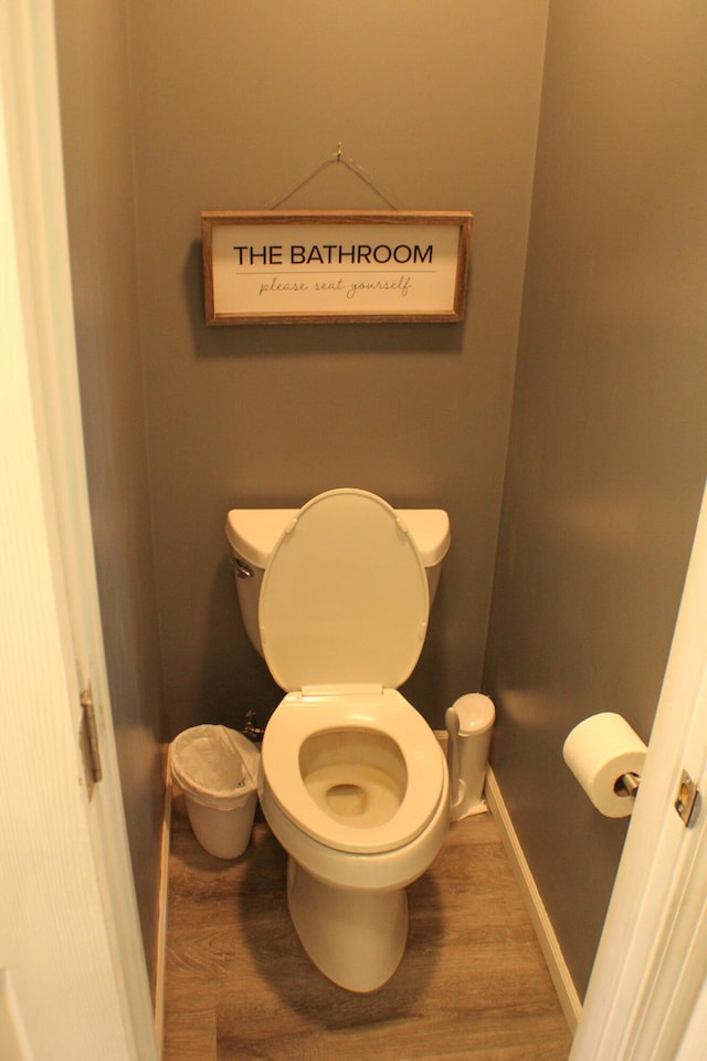 821 NW B Hwy, Osceola, MO 64776 - bathroom featuring toilet, wood finished floors, and baseboards