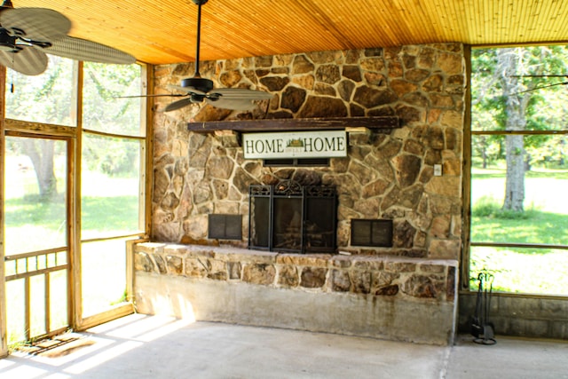 821 NW B Hwy, Osceola, MO 64776 - unfurnished living room with ceiling fan, plenty of natural light, a fireplace, and wooden ceiling