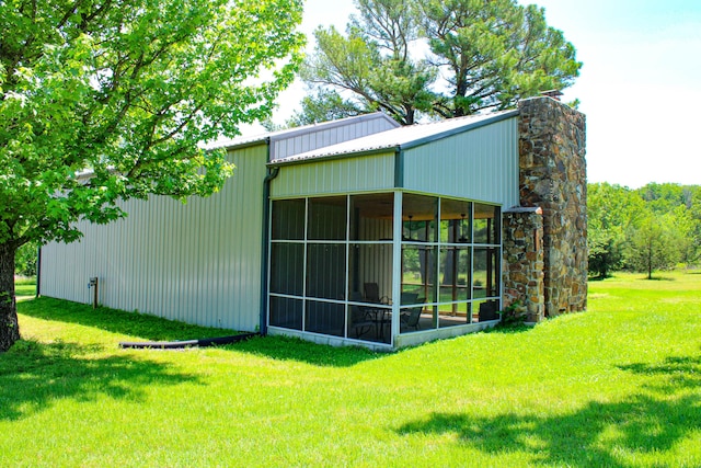 821 NW B Hwy, Osceola, MO 64776 - back of house with a sunroom, a yard, metal roof, and a chimney