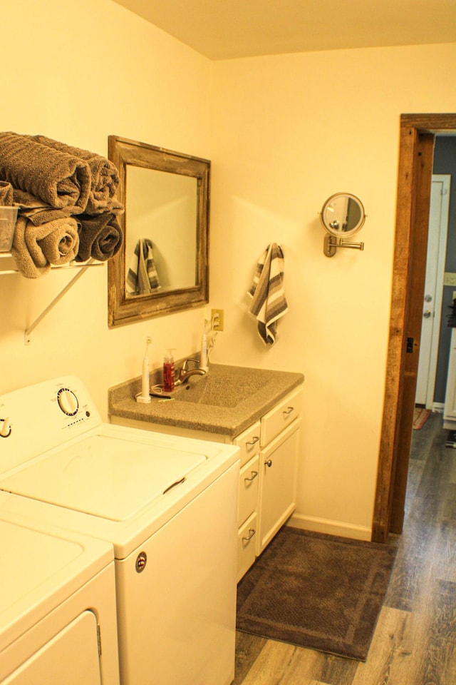 821 NW B Hwy, Osceola, MO 64776 - washroom featuring washing machine and clothes dryer, dark wood finished floors, cabinet space, and baseboards