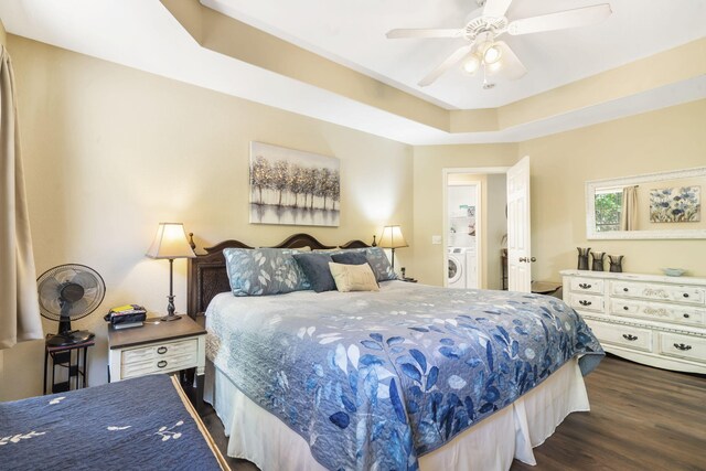 485 Eagle Dr, Forsyth, MO 65653 - bedroom with washer / dryer, dark wood-style flooring, a ceiling fan, and a tray ceiling