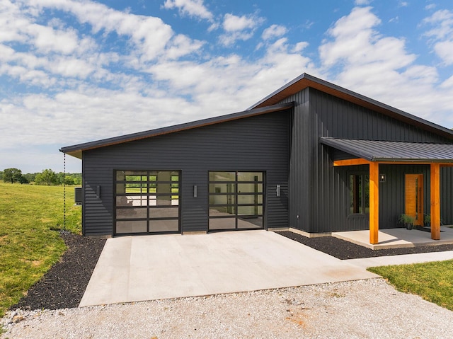 13213 State Highway M, Billings, MO 65610 - modern home with concrete driveway, board and batten siding, and a front yard