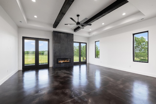 13213 State Highway M, Billings, MO 65610 - unfurnished living room featuring a tray ceiling, finished concrete floors, recessed lighting, a tiled fireplace, and a ceiling fan