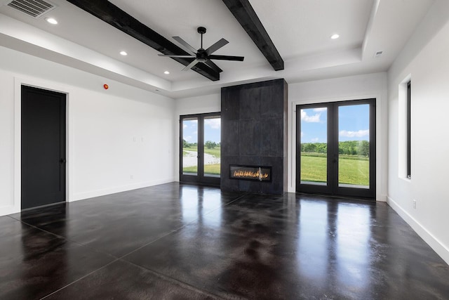13213 State Highway M, Billings, MO 65610 - unfurnished living room featuring finished concrete flooring, a raised ceiling, recessed lighting, beamed ceiling, and a tiled fireplace