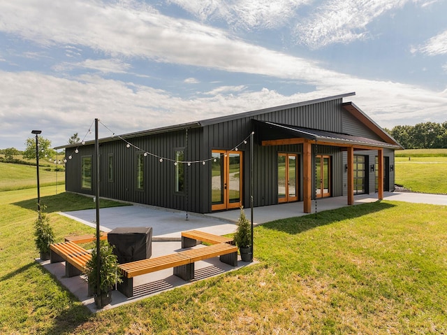 13213 State Highway M, Billings, MO 65610 - rear view of property featuring board and batten siding, a patio area, a lawn, and french doors