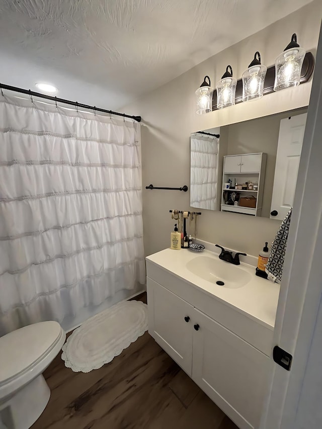 2510 W Madison St, Springfield, MO 65802 - full bath with toilet, vanity, and wood finished floors