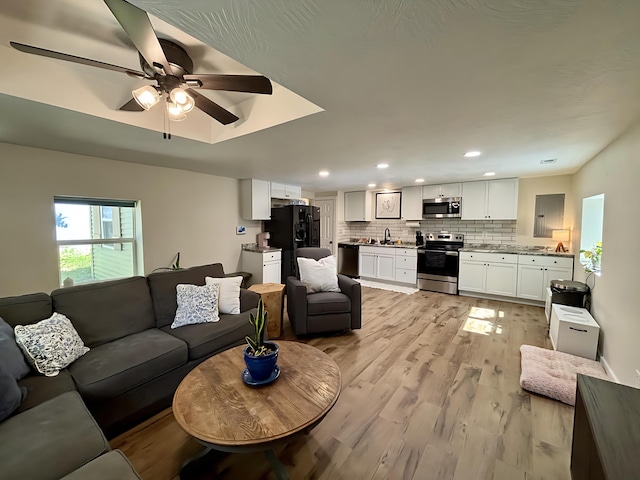 2510 W Madison St, Springfield, MO 65802 - living area featuring light wood-style flooring, ceiling fan, and recessed lighting