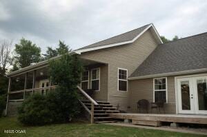 411 N Main St, Diamond, MO 64840 - rear view of house with french doors, a deck, stairs, and a yard