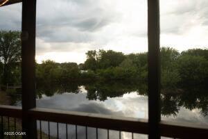 411 N Main St, Diamond, MO 64840 - water view featuring a forest