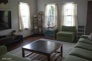 411 N Main St, Diamond, MO 64840 - living area with healthy amount of natural light and wood finished floors