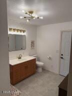 411 N Main St, Diamond, MO 64840 - bathroom featuring vanity, a chandelier, and toilet