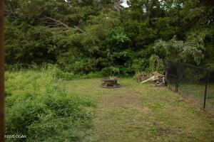 411 N Main St, Diamond, MO 64840 - view of grassy yard featuring an outdoor fire pit