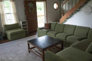 411 N Main St, Diamond, MO 64840 - living area with plenty of natural light and stairs
