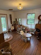 411 N Main St, Diamond, MO 64840 - living room featuring wood finished floors