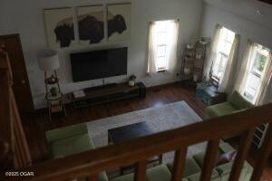 411 N Main St, Diamond, MO 64840 - living area with healthy amount of natural light and wood finished floors