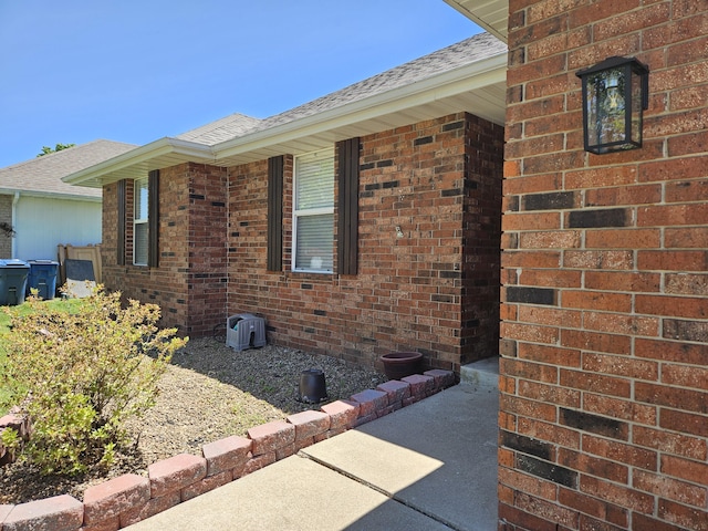 512 E Slim Wilson Blvd, Nixa, MO 65714 - view of side of property with a shingled roof and brick siding