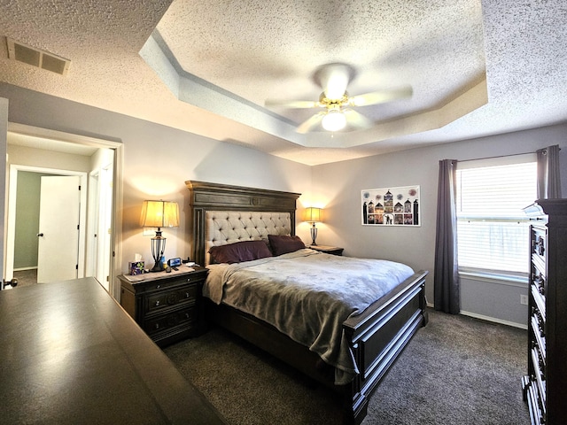 512 E Slim Wilson Blvd, Nixa, MO 65714 - bedroom with a textured ceiling, a tray ceiling, dark colored carpet, ceiling fan, and baseboards