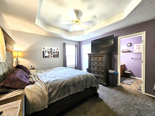512 E Slim Wilson Blvd, Nixa, MO 65714 - bedroom with carpet, a textured ceiling, a tray ceiling, ensuite bath, and ceiling fan