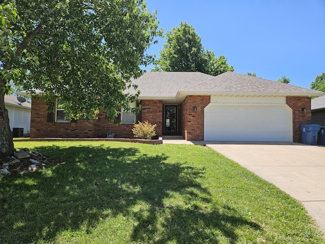 512 E Slim Wilson Blvd, Nixa, MO 65714 - ranch-style house with a garage, concrete driveway, a front yard, brick siding, and cooling unit