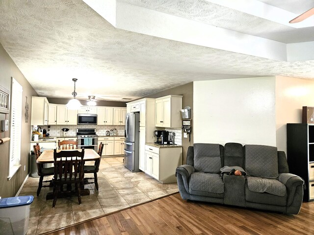 512 E Slim Wilson Blvd, Nixa, MO 65714 - living area with light wood-type flooring, a ceiling fan, and a textured ceiling