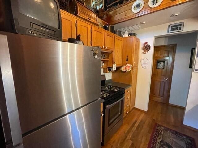 2382 Minnow Dr, Omaha, AR 72662 - kitchen featuring appliances with stainless steel finishes, dark wood finished floors, brown cabinetry, and open shelves