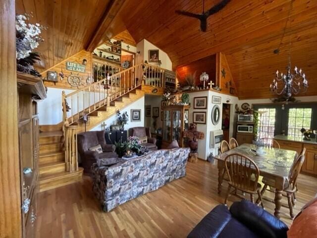 2382 Minnow Dr, Omaha, AR 72662 - living area featuring wood ceiling, high vaulted ceiling, stairway, wood finished floors, and a chandelier
