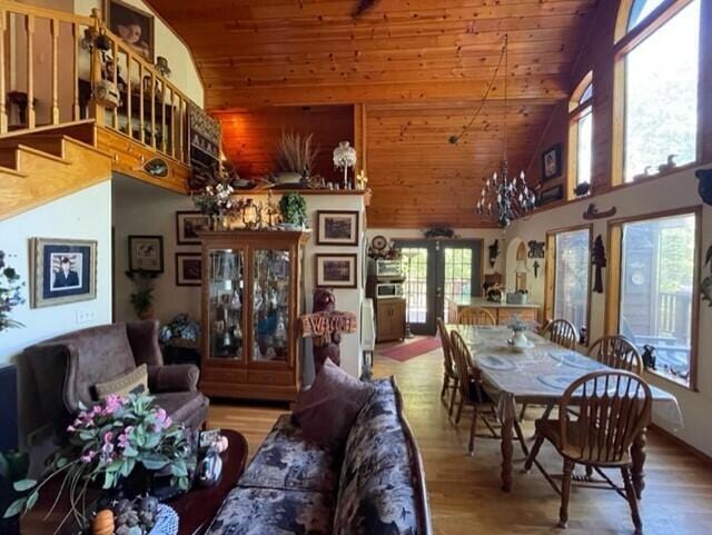 2382 Minnow Dr, Omaha, AR 72662 - living room featuring high vaulted ceiling, wood ceiling, wood finished floors, french doors, and stairs