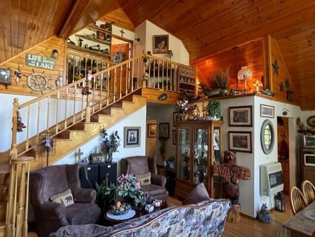 2382 Minnow Dr, Omaha, AR 72662 - living area with wood ceiling, heating unit, high vaulted ceiling, stairway, and wood finished floors