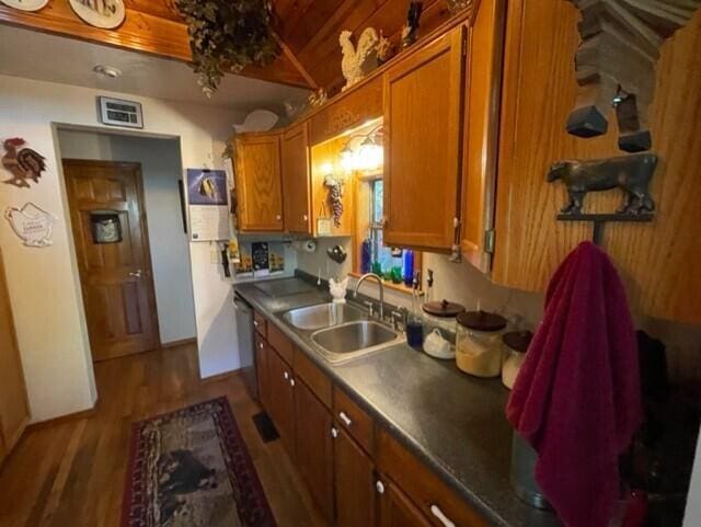 2382 Minnow Dr, Omaha, AR 72662 - kitchen featuring a sink, brown cabinets, dark wood-style flooring, dark countertops, and wood ceiling