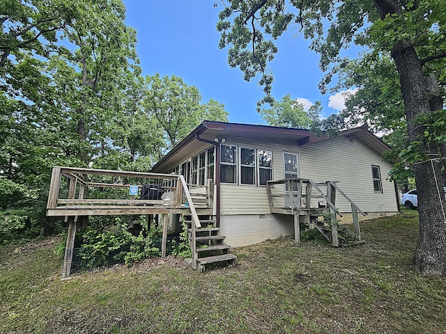22182 County Road 288, Pittsburg, MO 65724 - back of property featuring crawl space, stairs, a wooden deck, and a sunroom