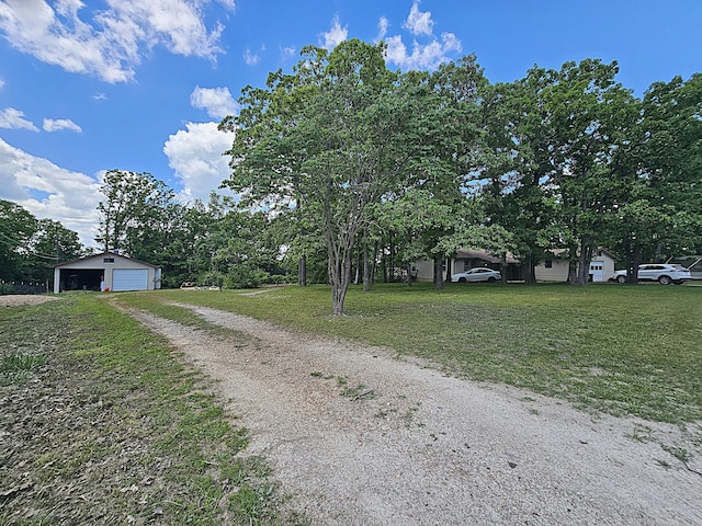 22182 County Road 288, Pittsburg, MO 65724 - view of front of house with a detached garage, a front lawn, an outdoor structure, and driveway