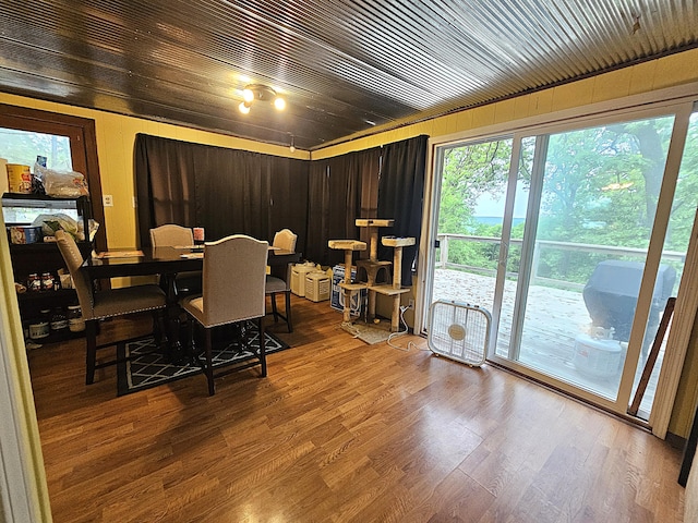 22182 County Road 288, Pittsburg, MO 65724 - dining room featuring wood finished floors, healthy amount of natural light, and wooden walls