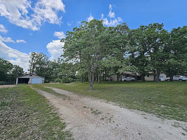 22182 County Road 288, Pittsburg, MO 65724 - view of front of house with a detached garage, a front lawn, an outdoor structure, and driveway